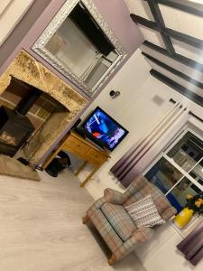 an overhead view of a living room with a tv at Custard creams cottage in Knaresborough