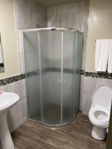 a shower stall in a bathroom with a toilet at Hotel Olivia in Nogales