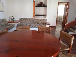 a living room with a wooden table and chairs at Hotel La Rinconada Tequisquiapan in Tequisquiapan