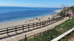 Sitio de CalahondaにあるVilla Monterray, Royal Beach, Calahonda - Beach Front Villaの砂浜と海の上の人々と一緒に楽しめる海岸