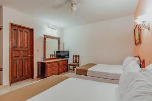 Postel nebo postele na pokoji v ubytování Hotel Santa María Mérida