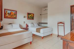 Postel nebo postele na pokoji v ubytování Hotel Santa María Mérida