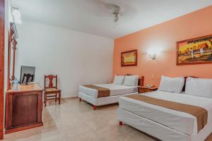 Postel nebo postele na pokoji v ubytování Hotel Santa María Mérida