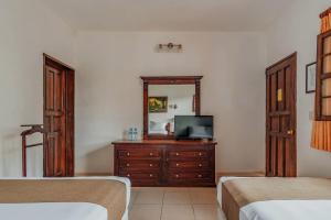 Postel nebo postele na pokoji v ubytování Hotel Santa María Mérida