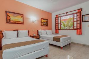 Postel nebo postele na pokoji v ubytování Hotel Santa María Mérida