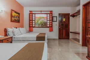 Postel nebo postele na pokoji v ubytování Hotel Santa María Mérida