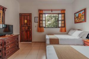 Postel nebo postele na pokoji v ubytování Hotel Santa María Mérida