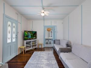 a living room with a couch and a tv at Pacific Family Retreat in Long Jetty