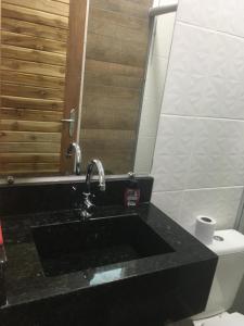 a bathroom with a sink and a toilet at Cristiane e José Neto in Salinópolis