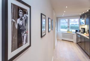 a hallway with pictures on the walls of a kitchen at Poseidon in Westerland (Sylt)
