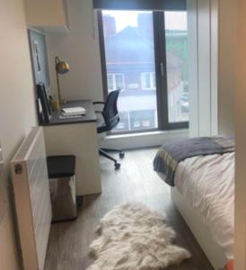 a bedroom with a bed and a desk and a desk at Student/one person accommodation flat in London