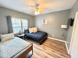 a bedroom with a bed and a ceiling fan at Charming, Beautiful, Treetop Loft, Prime Location in Wilmington