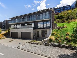 an exterior view of a house with a driveway at St Matthews Views Walter in Queenstown