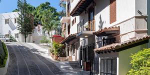 an empty street in a town with buildings at Marcela Resort & Spa in Puerto Vallarta