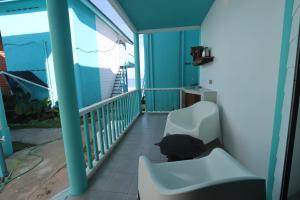 a person sitting in a chair on a balcony at Pondok Beach Shack in Tioman Island