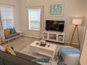 a living room with a couch and a tv at Contemporary 2-Bedroom Close to Downtown, Dining in Eugene