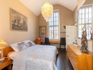 a bedroom with a large bed and a dining room at Apartment in Kruibeke at Wissekerke Castle in Kruibeke