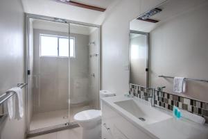 a bathroom with a toilet, sink, and bathtub at NRMA Agnes Water Holiday Park in Agnes Water