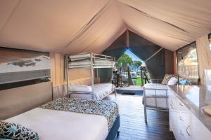 a tent with two bunk beds and a counter at NRMA Agnes Water Holiday Park in Agnes Water