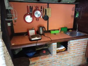 a kitchen with a counter with a sink and pots and pans at Teak house Chiang Mai in Chiang Mai +187 photos