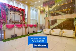 a wedding hall with a table and a stage at FabHotel Ruklo in Patna