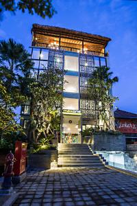 a building with stairs in front of it with lights at MaxOneHotels at Ubud - CHSE Certified in Ubud