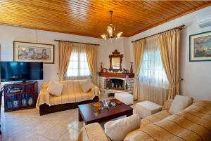 a living room with two couches and a tv at Evelina house in Plátanos