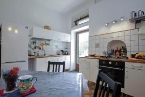 a kitchen with a table and a kitchen with white cabinets at Casaventre in Vietri sul Mare