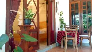 a room with a table and two chairs and a door at Wingate Homestay in Ella