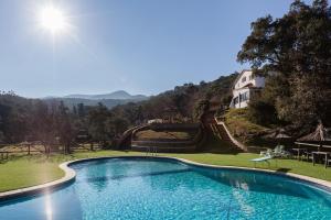 a swimming pool in a yard with a house in the background at Mas del Gall - Casa Nova in Tordera