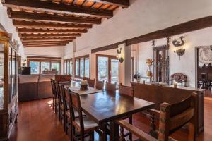 a dining room with a large wooden table and chairs at Mas del Gall - Casa Nova in Tordera