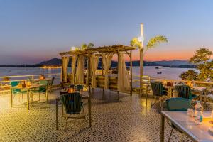 a restaurant on the beach with tables and chairs at Moustache Udaipur Luxuria in Udaipur