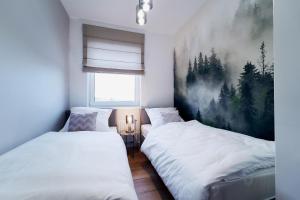 Postel nebo postele na pokoji v ubytování Apartament HORYZONT "ZŁOTA"