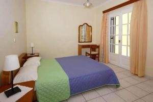 A bed or beds in a room at Natalia Apartment B with panoramic sea views of Agios Gordios bay