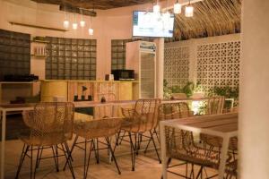 a restaurant with chairs and a table and a bar at Canggu Castle in Canggu