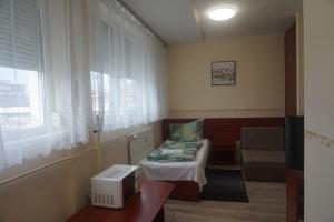 Posezení v ubytování Hotel Ajka Üzletház Panzió Ajka