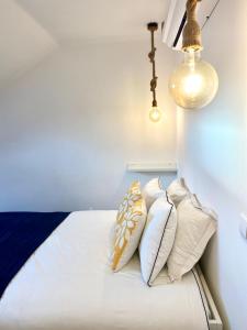 a bedroom with a bed with four pillows on it at Casa Tejo by Valada Village in Valada