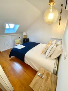 a bedroom with a large bed and a table at Casa Tejo by Valada Village in Valada