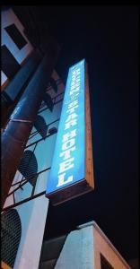 a blue sign on the side of a building at Golden Star Hotel in Dubai