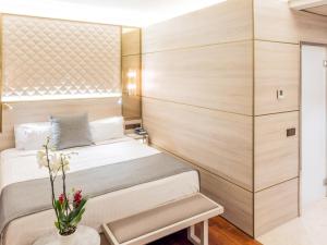 a hotel room with a bed and a dresser at Preciados in Madrid