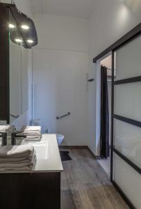a bathroom with a white sink and a mirror at Chambre d'Hôtes Les Jardins de Marie, SCI Charles III in Bernay