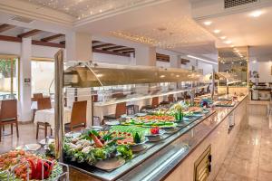 a buffet line with many plates of food at Hotel Biniamar in Cala Millor