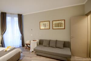 a bedroom with a couch and a table in a room at Il Genovino in Genoa