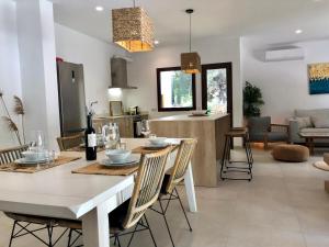 a dining room and living room with a table and chairs at Villa Can Ordinas in Alcudia