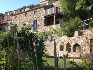 an old stone building with a balcony on top of it at Il Mandorlo in Montecorice