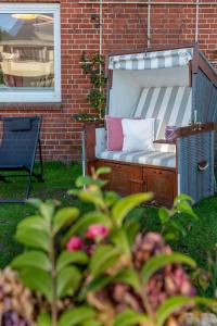 a bench in a yard next to a brick building at Thyra in Westerland