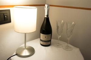 a bottle of wine and two wine glasses on a table at Il Genovino in Genoa