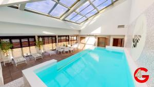 a pool in a house with a table and chairs at THE POOL HOUSE Cannes in Cannes