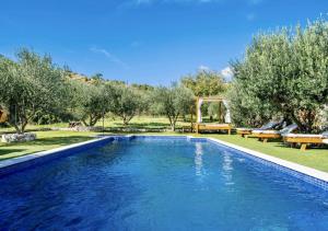 une piscine dans un parc avec des arbres et des bancs dans l'établissement Luki Home, à Dubrovnik