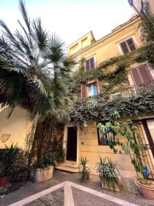 a building with a palm tree in front of it at B&B Insula Urbis in Rome